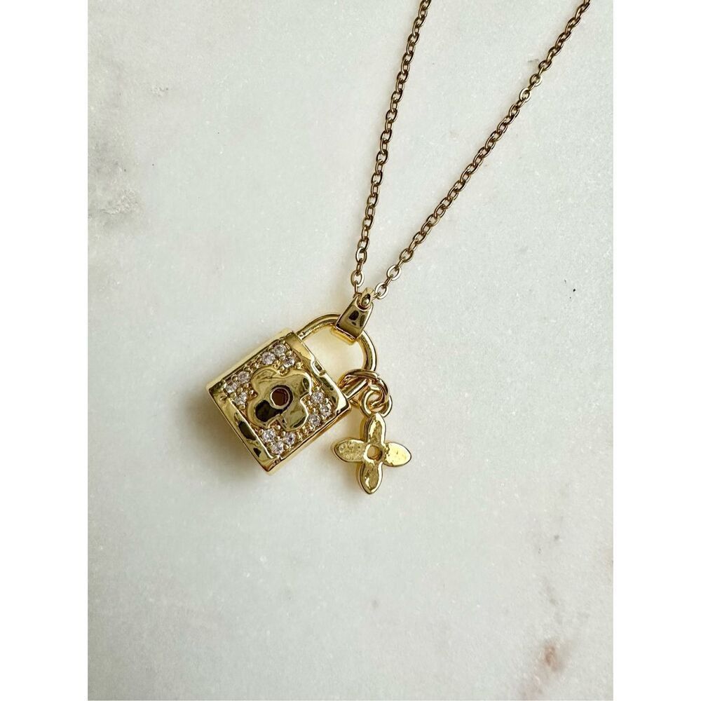 Cubic Zirconia Louie gold color lock and flower pendant necklace